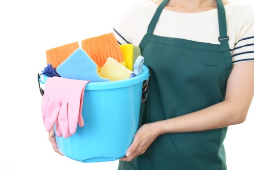 Carpet cleaning technician preparing equipment safely in a Watford home