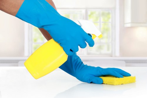 Cleaner wearing PPE while operating carpet cleaning equipment