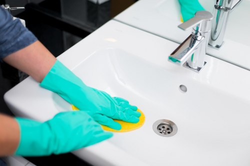 Technician managing carpet cleaning tools and cables carefully